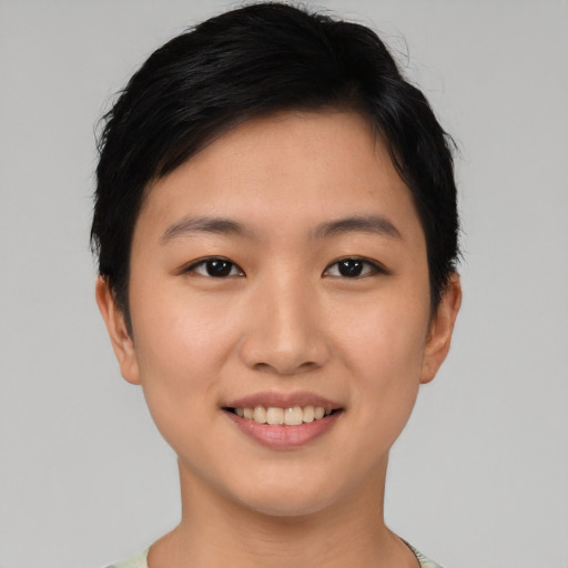 Joyful asian young-adult female with short  black hair and brown eyes