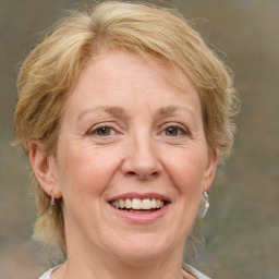 Joyful white adult female with medium  brown hair and blue eyes