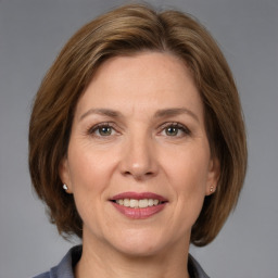 Joyful white adult female with medium  brown hair and grey eyes