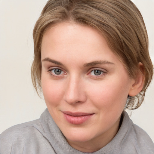 Joyful white young-adult female with medium  brown hair and blue eyes