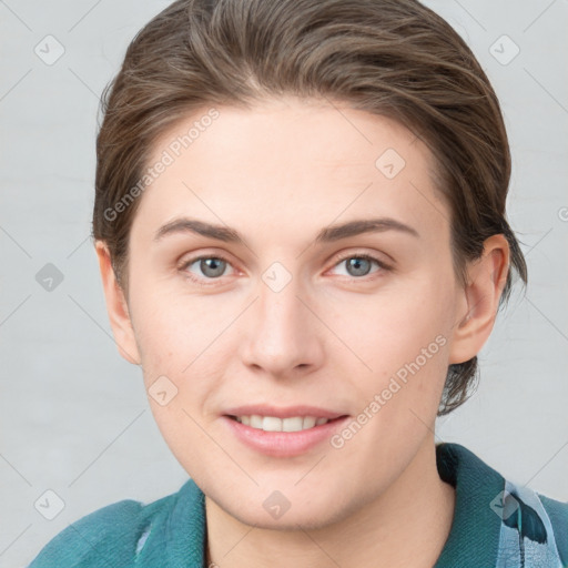 Joyful white young-adult female with short  brown hair and blue eyes