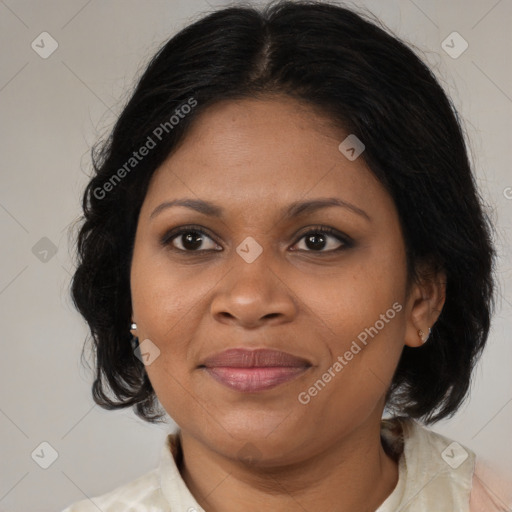 Joyful black adult female with medium  brown hair and brown eyes