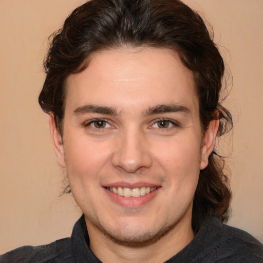 Joyful white young-adult male with medium  brown hair and brown eyes