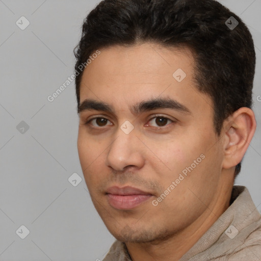 Joyful latino young-adult male with short  black hair and brown eyes