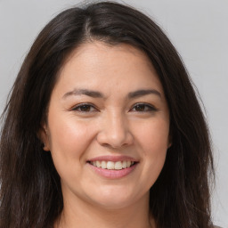 Joyful white young-adult female with long  brown hair and brown eyes