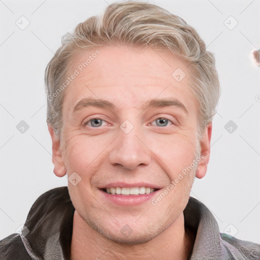 Joyful white adult male with short  brown hair and blue eyes