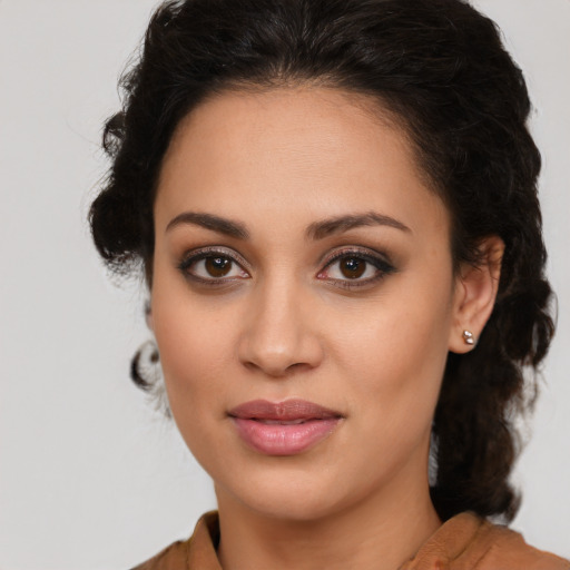 Joyful latino young-adult female with medium  brown hair and brown eyes