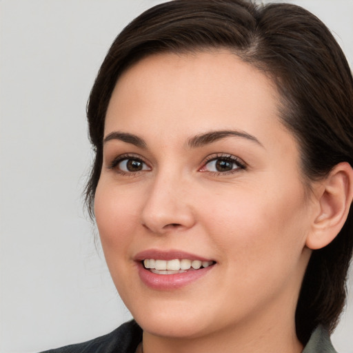 Joyful white young-adult female with medium  brown hair and brown eyes