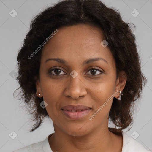 Joyful black adult female with medium  brown hair and brown eyes