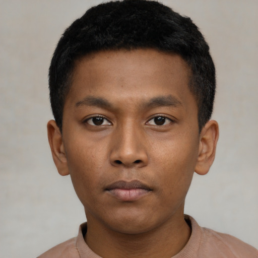 Neutral latino young-adult male with short  black hair and brown eyes