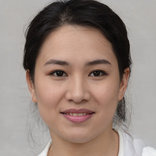 Joyful asian young-adult female with medium  brown hair and brown eyes