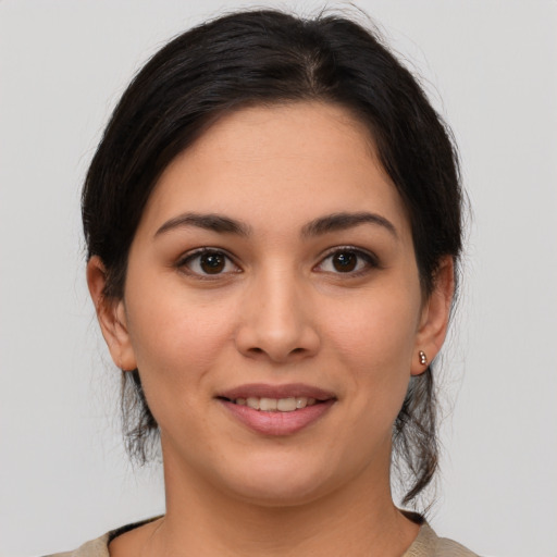 Joyful white young-adult female with medium  brown hair and brown eyes