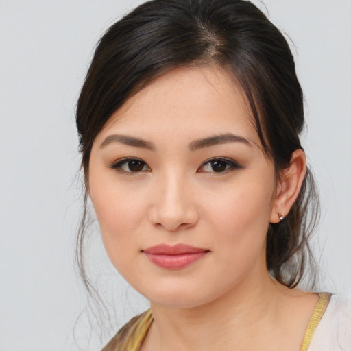 Joyful asian young-adult female with medium  brown hair and brown eyes