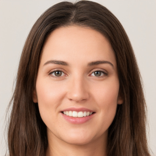 Joyful white young-adult female with long  brown hair and brown eyes