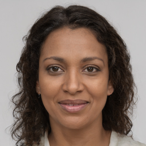 Joyful black young-adult female with medium  brown hair and brown eyes