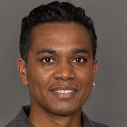 Joyful black young-adult male with short  black hair and brown eyes