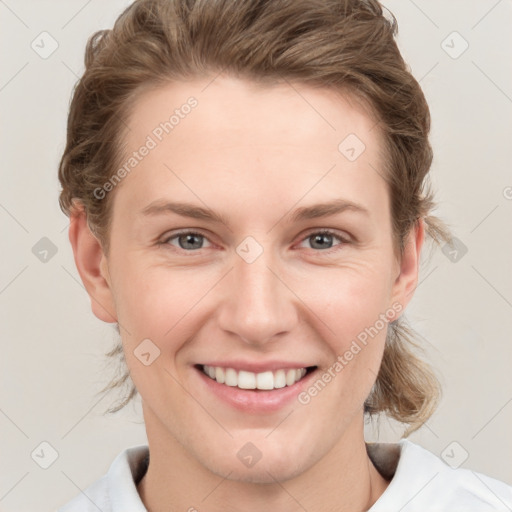 Joyful white young-adult female with short  brown hair and grey eyes