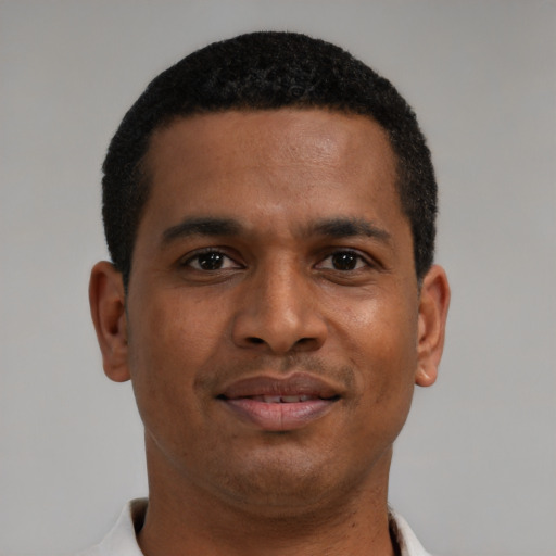 Joyful latino young-adult male with short  brown hair and brown eyes