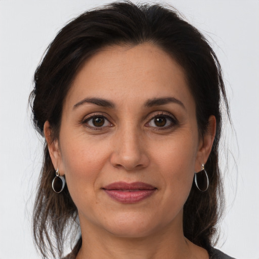 Joyful white adult female with medium  brown hair and brown eyes