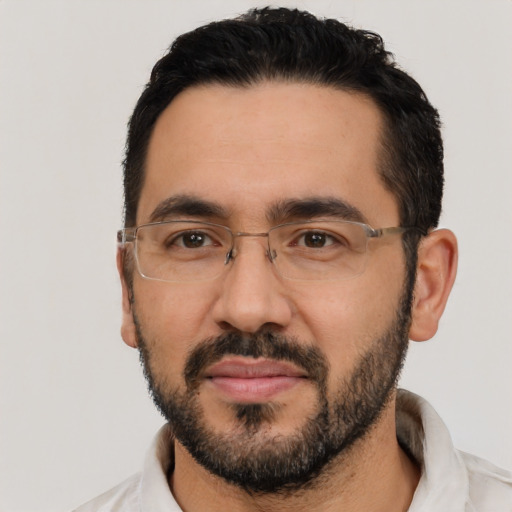 Joyful latino adult male with short  black hair and brown eyes