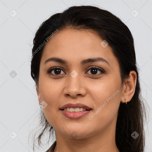 Joyful latino young-adult female with long  brown hair and brown eyes