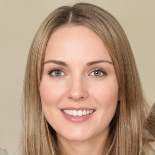 Joyful white young-adult female with long  brown hair and green eyes