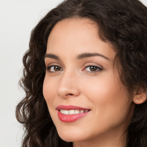 Joyful white young-adult female with long  brown hair and brown eyes