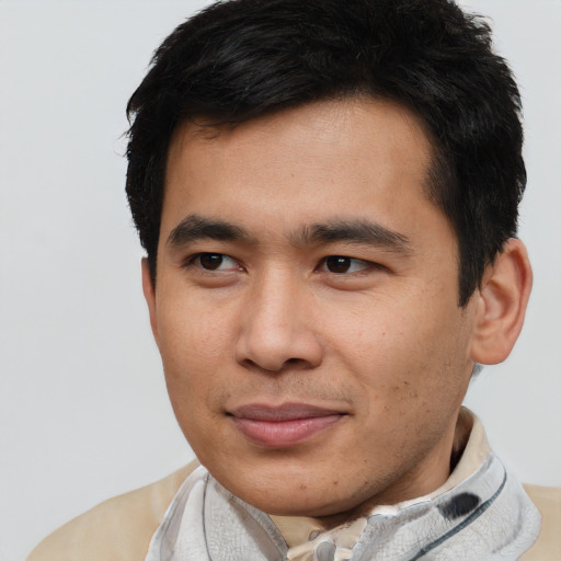 Joyful asian young-adult male with short  brown hair and brown eyes
