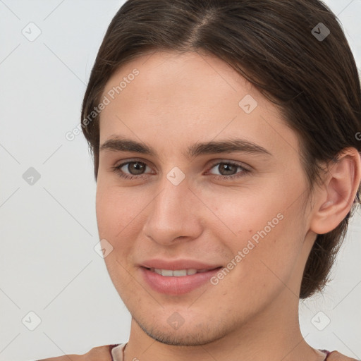 Joyful white young-adult female with short  brown hair and brown eyes