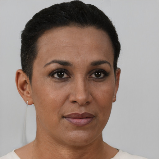 Joyful black adult female with short  brown hair and brown eyes