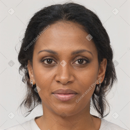 Joyful black adult female with medium  brown hair and brown eyes