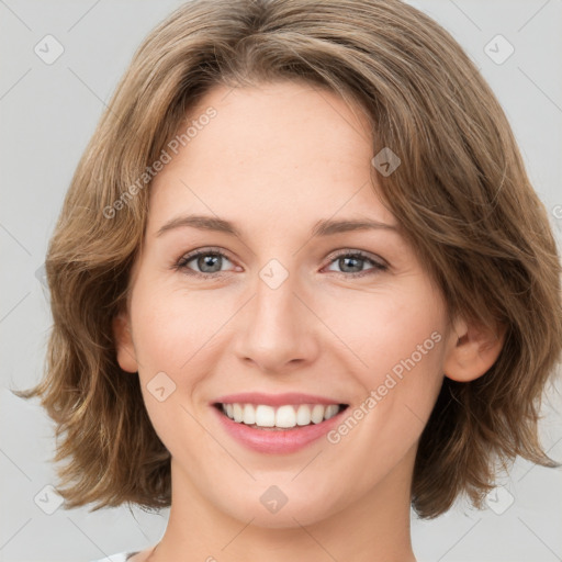 Joyful white young-adult female with medium  brown hair and green eyes