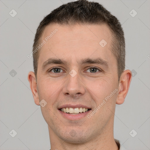 Joyful white young-adult male with short  brown hair and brown eyes