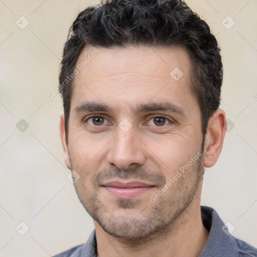 Joyful white young-adult male with short  black hair and brown eyes