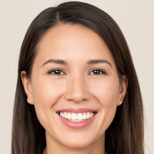 Joyful white young-adult female with long  brown hair and brown eyes