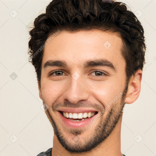 Joyful white young-adult male with short  black hair and brown eyes