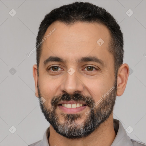 Joyful white adult male with short  black hair and brown eyes