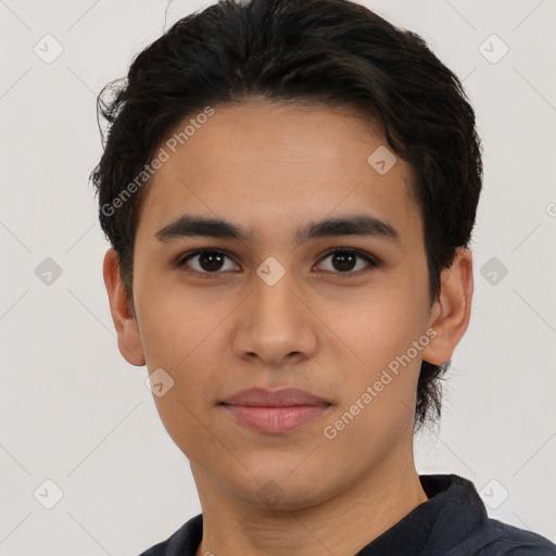 Joyful latino young-adult male with short  brown hair and brown eyes