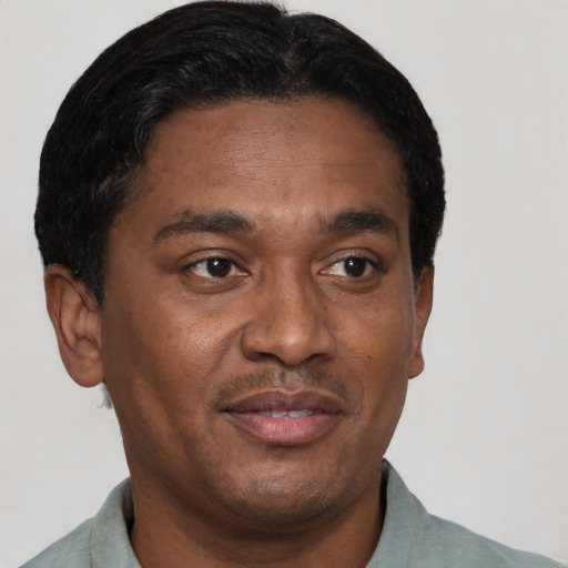 Joyful latino adult male with short  black hair and brown eyes