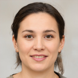 Joyful white young-adult female with medium  brown hair and brown eyes