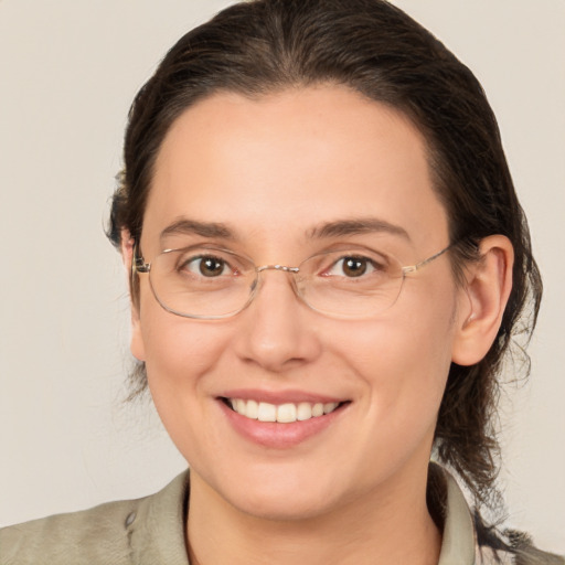 Joyful white adult female with medium  brown hair and brown eyes