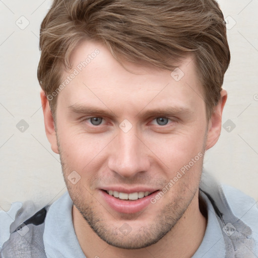 Joyful white young-adult male with short  brown hair and grey eyes