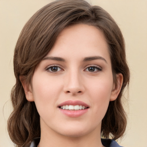 Joyful white young-adult female with medium  brown hair and green eyes