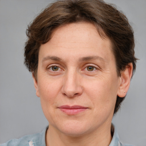 Joyful white adult female with short  brown hair and grey eyes