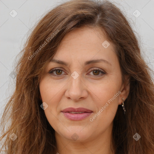 Joyful white adult female with long  brown hair and brown eyes