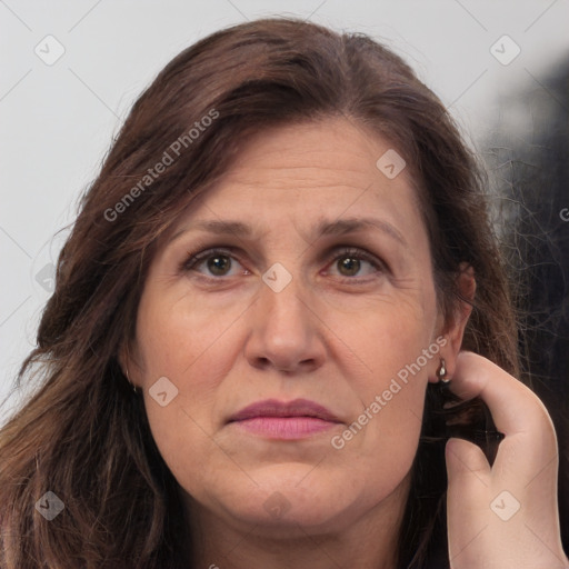 Joyful white adult female with long  brown hair and brown eyes