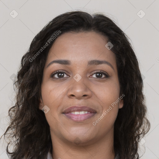 Joyful black young-adult female with long  brown hair and brown eyes