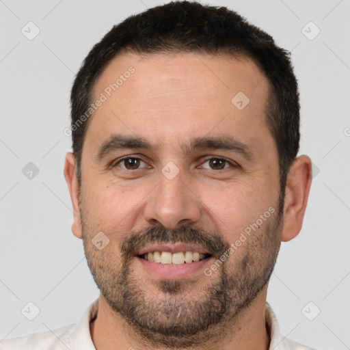 Joyful white adult male with short  brown hair and brown eyes