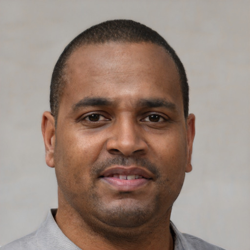 Neutral latino adult male with short  black hair and brown eyes