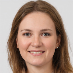 Joyful white young-adult female with long  brown hair and grey eyes